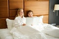 Waking up guy and girlfriend study the menu in bed Royalty Free Stock Photo