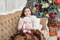 Waking up. Magical moment. Christmas morning. Happy new year. Little girl smiling face wake up near christmas tree Royalty Free Stock Photo