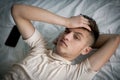 Waking up a teenage boy in bed in the morning Royalty Free Stock Photo