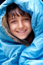 Waking up to a fresh new day...camping rocks. Portrait of a young boy wrapped in his sleeping bag. Royalty Free Stock Photo