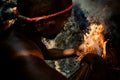 Walarano village, Malekula Island / Vanuatu - 9 JUL 2016 : local tribal man blowing to a fire to light it on the traditional Royalty Free Stock Photo