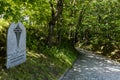 Stone board at Station of the Cross plaque in mountains