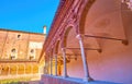 Walk along the covered gallery of small cloister of Certosa di P