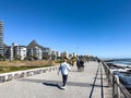 A walk along the Sea Point Promenade with Lions Head in the distance