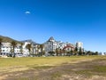 A walk along the Sea Point Promenade with paragliders and Lions Head in the distance