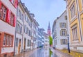 Walk on Augustinergasse street, passing historical residential buildings with Basler Munster on background, Switzerland