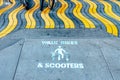 Walk Bikes and Scooters sign on ground Royalty Free Stock Photo