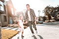 Stylish handsome father wearing jeans walking with daughter Royalty Free Stock Photo