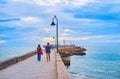 Walk down stone levee to the San Sebastian Castle, Cadiz, Spain