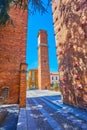 Walk between medieval towers on Piazza Leonardo da Vinci in old Pavia, Italy Royalty Free Stock Photo