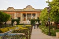 Walk in persian garden of Naranjestan-e Ghavam complex with rows of trees and arches, Shiraz, Iran.