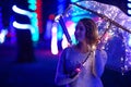 Walk through the night rainy city with an umbrella and lights. Creative photo