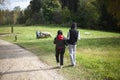 Walk in the park. A man and a woman stand on the road in warm autumn Royalty Free Stock Photo