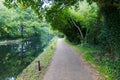 Walk path in park hike trail at water channels in Woking