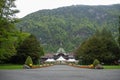 Walk path to medieval europe style building on fresh green mountain background