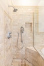 A shower with square stones tiles.