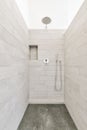 a white tiled bathroom with a shower in it