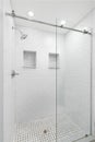 A walk-in shower with white subway tiles.