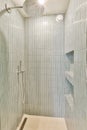 a shower with blue tiled walls and a shower