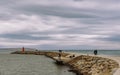 Walk to the lighthouse on the breakwater Royalty Free Stock Photo