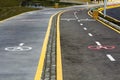 Walk way and bicycle lane signs on the asphalt road surface Royalty Free Stock Photo