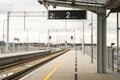 Walk way in train station with no people. Empty Passanger train railway station platform. Sign board with number of Royalty Free Stock Photo