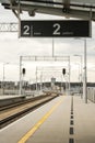 Walk way in train station with no people. Empty Passanger train railway station platform. Sign board with number of Royalty Free Stock Photo