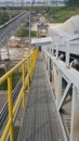 Walk way with yellow handrail in side of Stone Belt conveyors Royalty Free Stock Photo