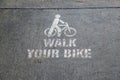 Walk your bike stencil in white paint