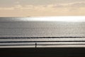 Walker on Beach with Sunset Royalty Free Stock Photo