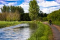 Walker and dog on towpath Royalty Free Stock Photo