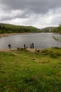 A walker looking across Derwent reservoir towards Howden Dam Royalty Free Stock Photo