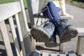 Walking boots muddy resting after walk ramble sitting on bench