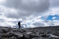 Walker silhouette on rock field on Scottish Highland Munro Royalty Free Stock Photo