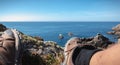 Walker taking a break on the rocky coast of the island of Yeu