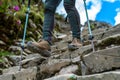 walker using hiking poles on a steep terrace incline