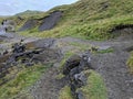 Walkers on the collapsed road beneath Mam Tor