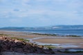 Walkers on Nairn beach at low tide North Scotland UK