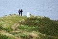 Walkers at triangulation station pillar Royalty Free Stock Photo