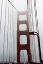 Walking across the Golden Gate Bridge on a very foggy day with the towers shrouded in fog, San Francisco, California Royalty Free Stock Photo