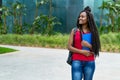 Walking african american female student with amazing hairstyle Royalty Free Stock Photo