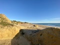 Walking along the sandy beach of Praia Da Gale in Algarve, south of Portugal