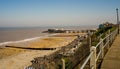 A view down over Cromer beach and the distant pier from the cliff top path Royalty Free Stock Photo