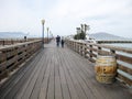 Walking along long wooden pier