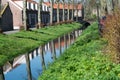 Walking along the small canal in old Dutch village, sunny Sunday Royalty Free Stock Photo