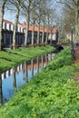 Walking along the small canal in old Dutch village, sunny Sunday Royalty Free Stock Photo