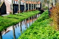 Walking along the small canal in old Dutch village, sunny Sunday Royalty Free Stock Photo