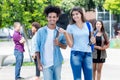 Walking american young adult student and latin hipster student Royalty Free Stock Photo