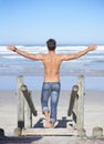 Walking, arms up and back of man at the beach on tropical vacation, adventure or holiday. Travel, stairs and confident Royalty Free Stock Photo