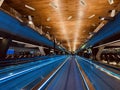 Walking automatic escalators around an airport